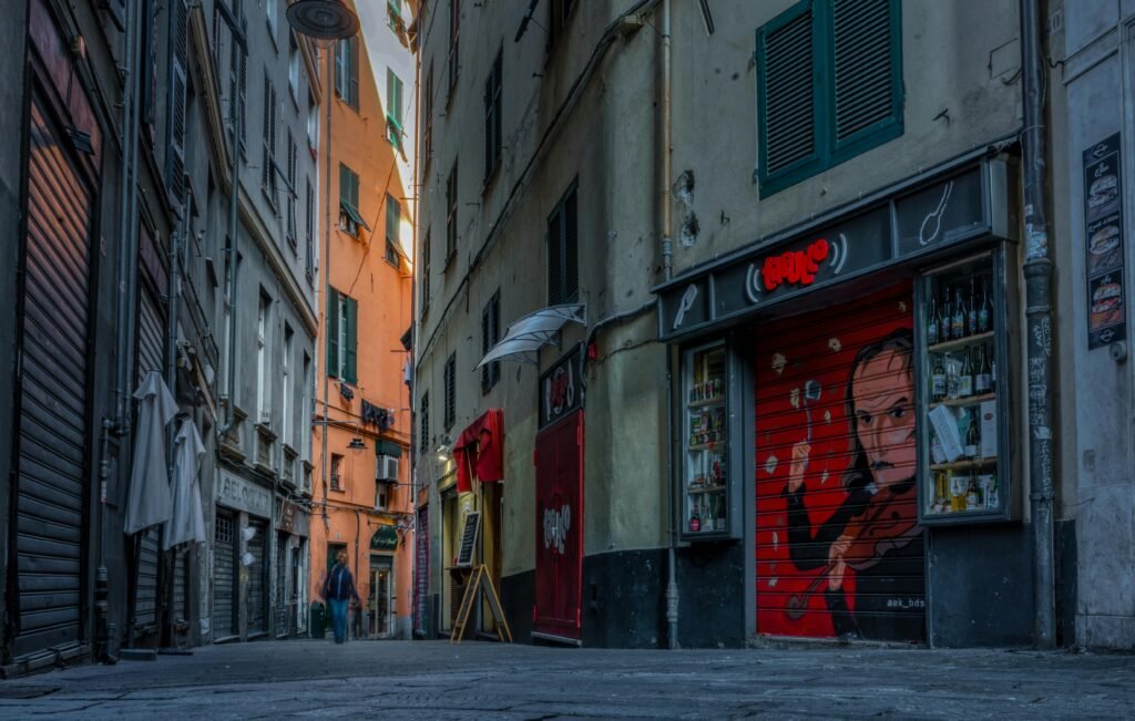 About Explore the vibrant alleyways of Genova, featuring colorful graffiti and historic architecture.